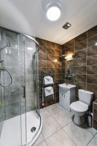a bathroom with a shower and a toilet and a sink at Fisher's Hotel in Pitlochry