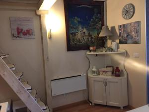 a room with a staircase and a clock on the wall at Apartment Marija- Kopaonik centar in Kopaonik +57 photos