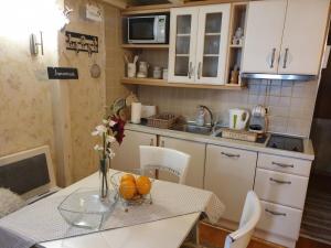 a small kitchen with a table with oranges on it at Apartment Marija- Kopaonik centar in Kopaonik