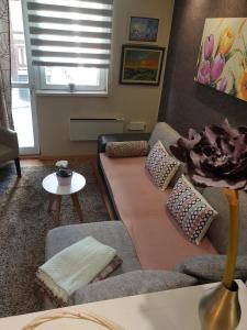 a living room with a couch and a table at Apartment Marija- Kopaonik centar in Kopaonik