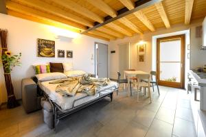 a bedroom with a bed and a table and a kitchen at Old Town Apartments in Tirano