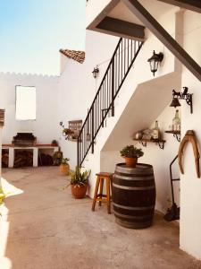 a tasting room with a barrel and stairs at La casita Santa Bárbara in Macastre