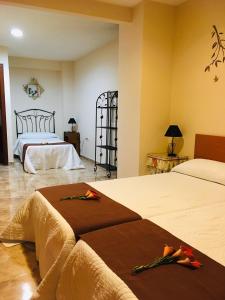 a hotel room with two beds with brown blankets at La casita Santa Bárbara in Macastre