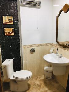 a bathroom with a toilet and a sink at La casita Santa Bárbara in Macastre +27 photos