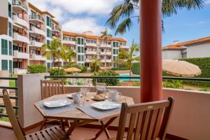 a table on the balcony of a resort at Varandas do Funchal II by An Island Apart in Funchal
