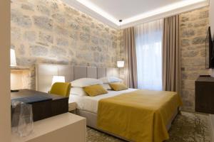 Postel nebo postele na pokoji v ubytování Heritage Hotel Leon Coronato