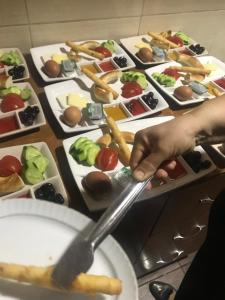 a person holding a spoon in front of plates of food at Guney Konak in Safranbolu