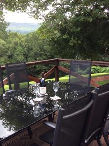 a table with glasses and a bottle of wine on it at Brandoch Lodge in Logierait