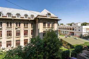 a large building with a roof on top of it at Hotel Parliament in Bucharest