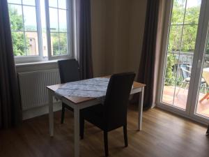 a dining room table with chairs and a window at Apartment Luiza Funtana in Funtana