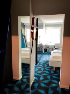 a room with two beds and a mirror at Magic Hotel Solheimsviken in Bergen