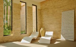 two white chairs in a room with windows at Capovaticano Resort Thalasso Spa in Capo Vaticano