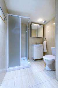 a bathroom with a shower and a toilet and a sink at Kama Lifestyle Apartments in Protaras