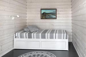 a bedroom with a bed in a white wall at Villa Leponiemi in Keuruu