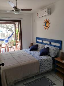 a bedroom with a bed with a blue headboard at Apartamento Solar do Forte - Praia do Forte in Praia do Forte
