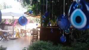 a patio with chairs and blue potted plants at Kybele Hotel Gocek in Göcek