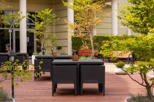 a row of tables and chairs on a patio at Hotel Jan Sander in Aleksandr&oacute;w Ł&oacute;dzki