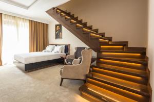 a hotel room with a staircase and a bed at Waikiki Apartments in Tivat