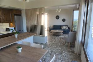 a kitchen and living room with a table and chairs at Arkadins in Zakynthos Town