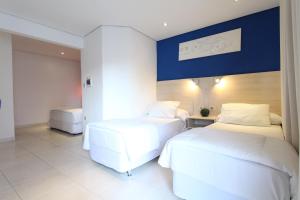 Un ou plusieurs lits dans un hébergement de l'établissement Danieri Asunción Hotel