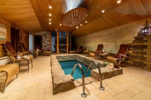 a large room with a pool in a house at Baltic Beach Hotel & SPA in Jūrmala