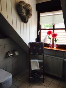 a bathroom with a window with a heart on the wall at Gästehaus Sellemols Ferienhaus Winzer in Heuchelheim-Klingen +43 photos