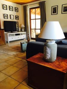 a living room with a lamp on a table at Gästehaus Sellemols Ferienhaus Winzer in Heuchelheim-Klingen