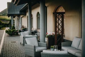 a group of chairs and tables on a patio at Pensjonat Jurkowski Wellness & Spa in Ochotnica Dolna