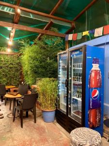 a drink cooler with a bottle of coke on a patio at Blue House Youth Hostel in Quito