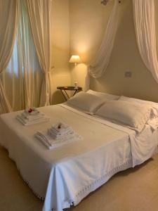 a white bed with two towels on top of it at Villa Gruccione in Fossombrone