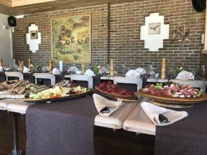 a table with several plates of food on it at Hotel Le Postillion in Bettmeralp