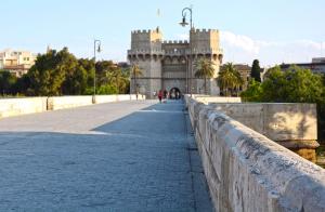 a bridge over a road with a castle in the background at Espai One Valencia in Valencia