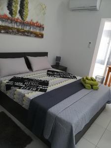 a bedroom with a large bed with a blue blanket at Luxury Apartment close to seafront in Sliema
