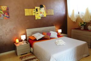 a bedroom with a white bed with two lamps on it at CasaBlueLive in Venafro