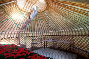
A bed or beds in a room at Jyrgalan Yurt Lodge
