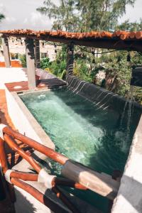 a pool of water with a gazebo at Casa Mech in Holbox Island