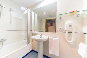 a bathroom with a sink, toilet and shower stall at Hotel Monreal Jumilla in Jumilla