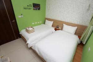 Postel nebo postele na pokoji v ubytování Mayu Hotel