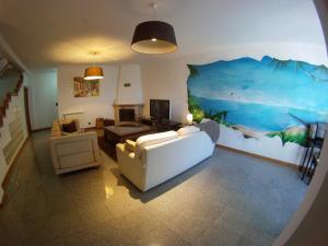a living room with a large painting on the wall at Cabedelo guest house in Viana do Castelo