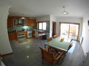 a kitchen and dining room with a table and chairs at Cabedelo guest house in Viana do Castelo