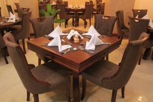 a wooden table with napkins on top at Empolos Hotel Nakuru in Nakuru