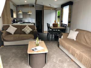 a living room with a couch and a table at Newquay Blue Water in Newquay