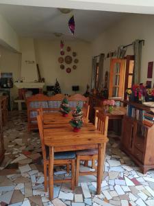 a living room with a wooden table with christmas trees on it at Meva Guesthouse in Antananarivo