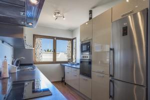 a kitchen with stainless steel appliances and a window at Villa Illusion by Golf Club in Caleta De Fuste