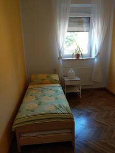 a small bedroom with a bed and a window at Storchennest an der Spree in Radinkendorf in Beeskow