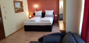 um quarto de hotel com uma cama e um sofá em Hotel-Villa Lalee em Dresden