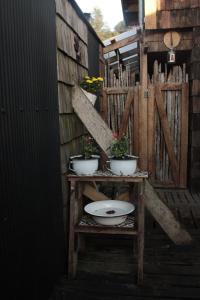 a toilet on a wooden stand with plants on it at Palafito Ayün in Castro