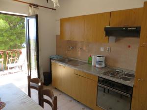 a kitchen with a sink and a stove at Apartments and Rooms Rogosic in Hvar