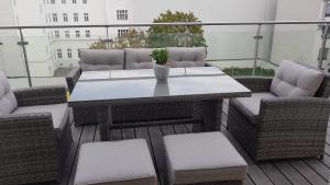 a patio with a table and chairs on a balcony at Loft #11 mit großer Loggia und Terrasse in Vienna