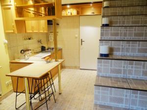 a kitchen with a counter and a table in it at Familijny Apartament z Garażem in Legnica